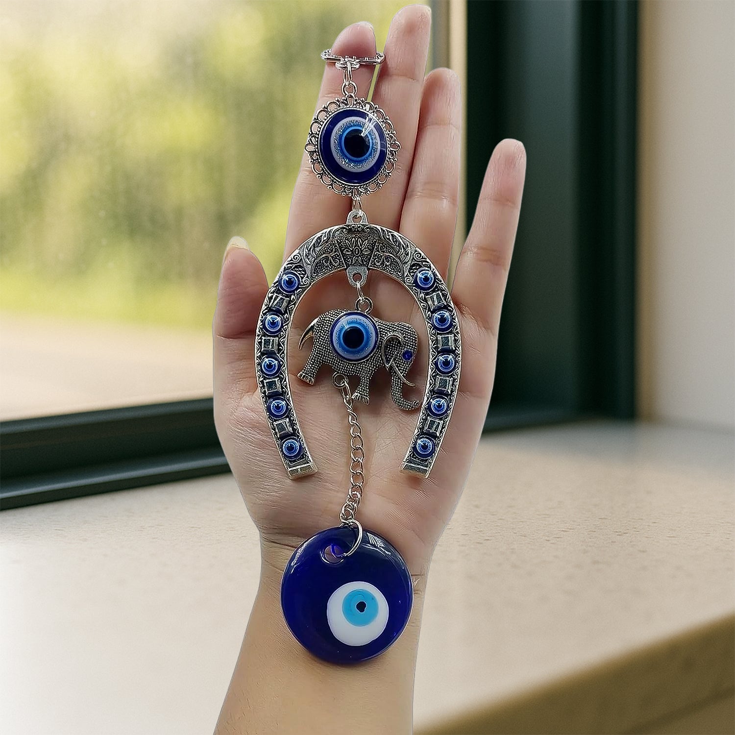 Decorative evil eye wind chime with elephant and horseshoe motifs, hanging ornament by Wukusy, featuring colorful beads and charms