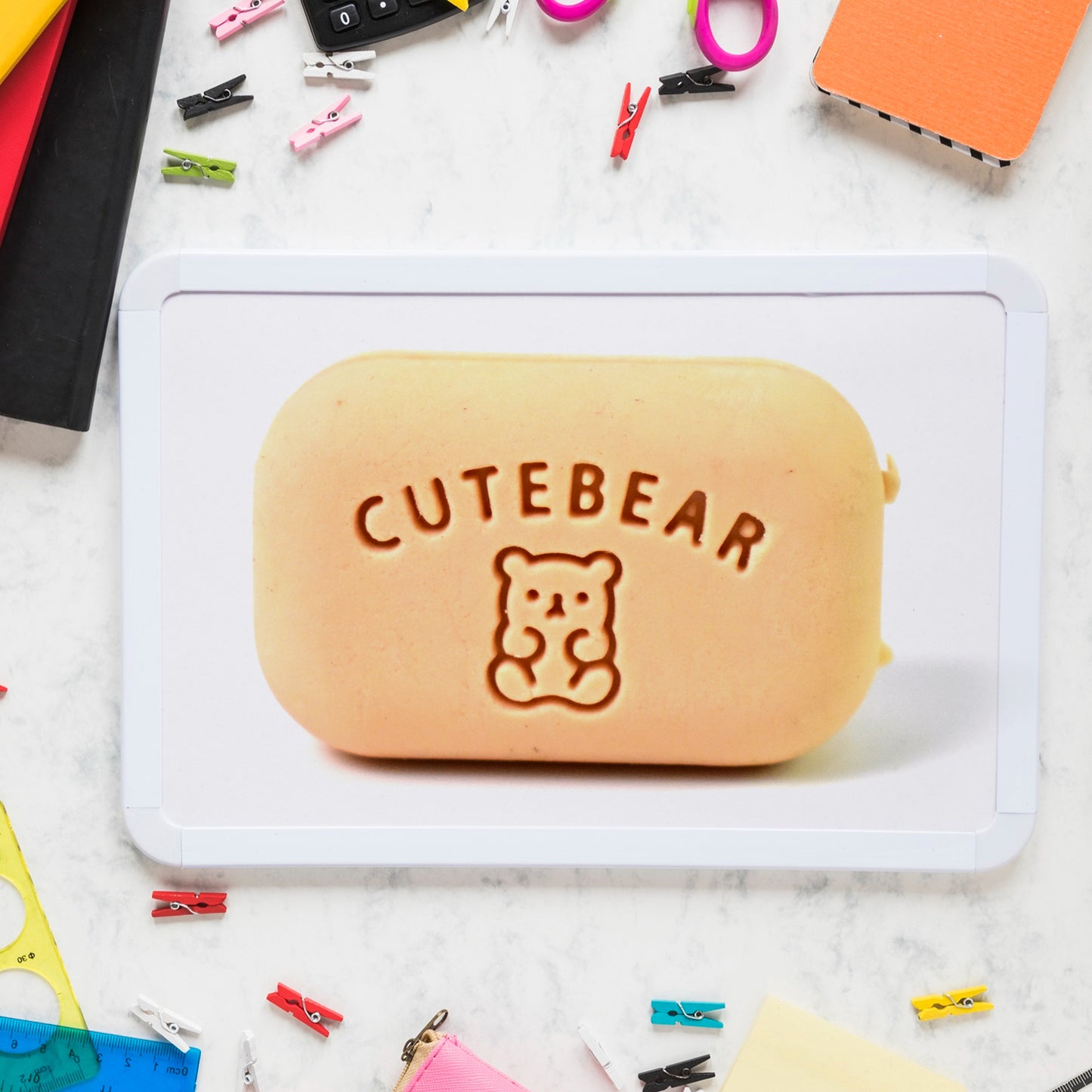 Cute soap-shaped eraser with plastic case by Wukusy, ideal for office use, shown with the eraser inside the clear case.