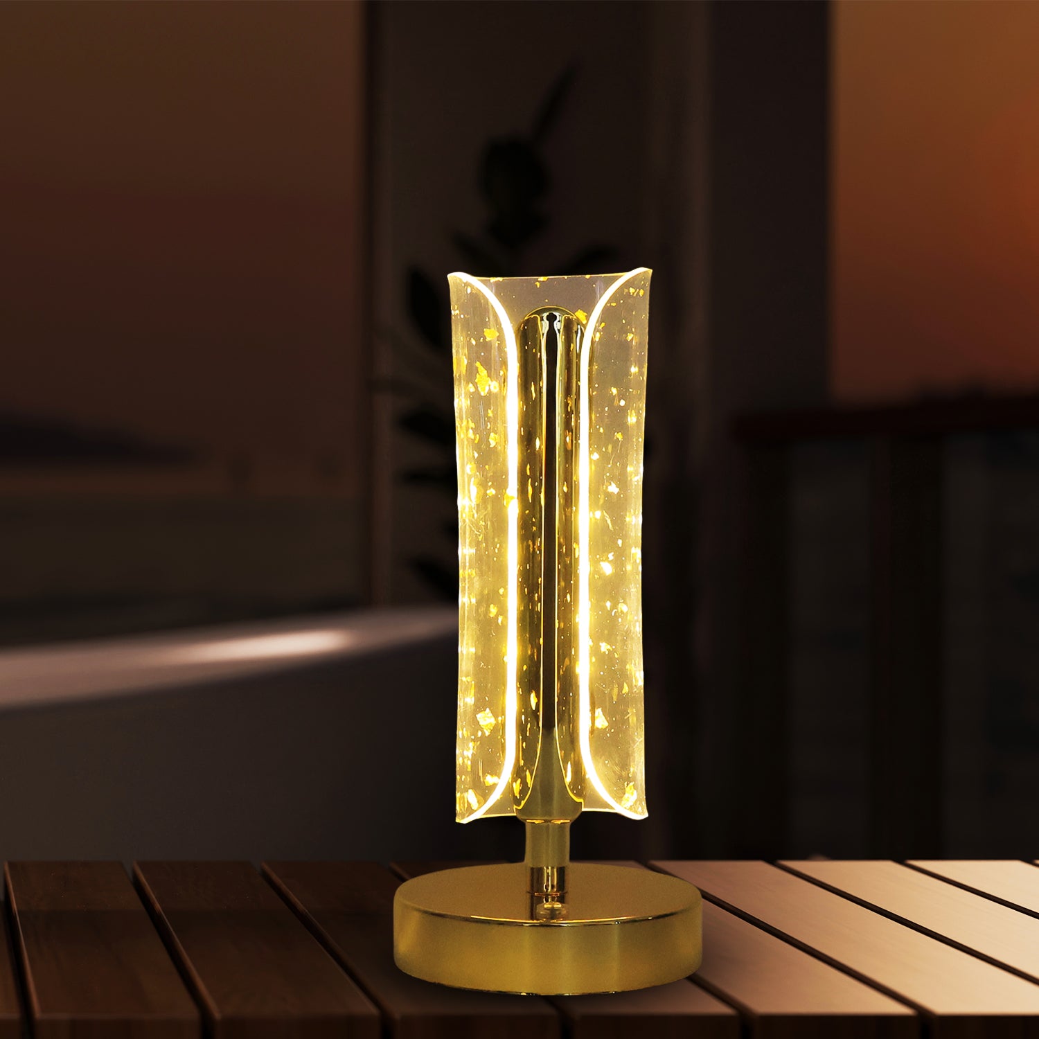 Wukusy crystal table lamp with a sleek base and clear glass shade, illuminated to showcase its elegant design.