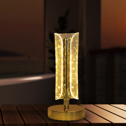 Wukusy crystal table lamp with a sleek base and clear glass shade, illuminated to showcase its elegant design.