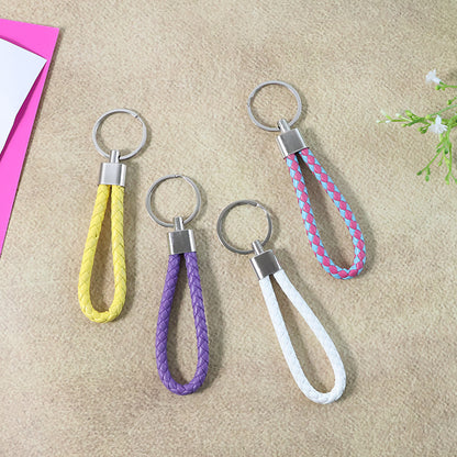 Set of four braided loop keychains by Wukusy with colorful woven designs on a neutral background.