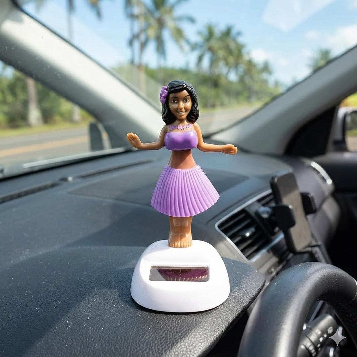 Wukusy solar-powered dancing hula doll bobble toy on car dashboard, featuring a colorful hula dancer with a grass skirt and floral top.