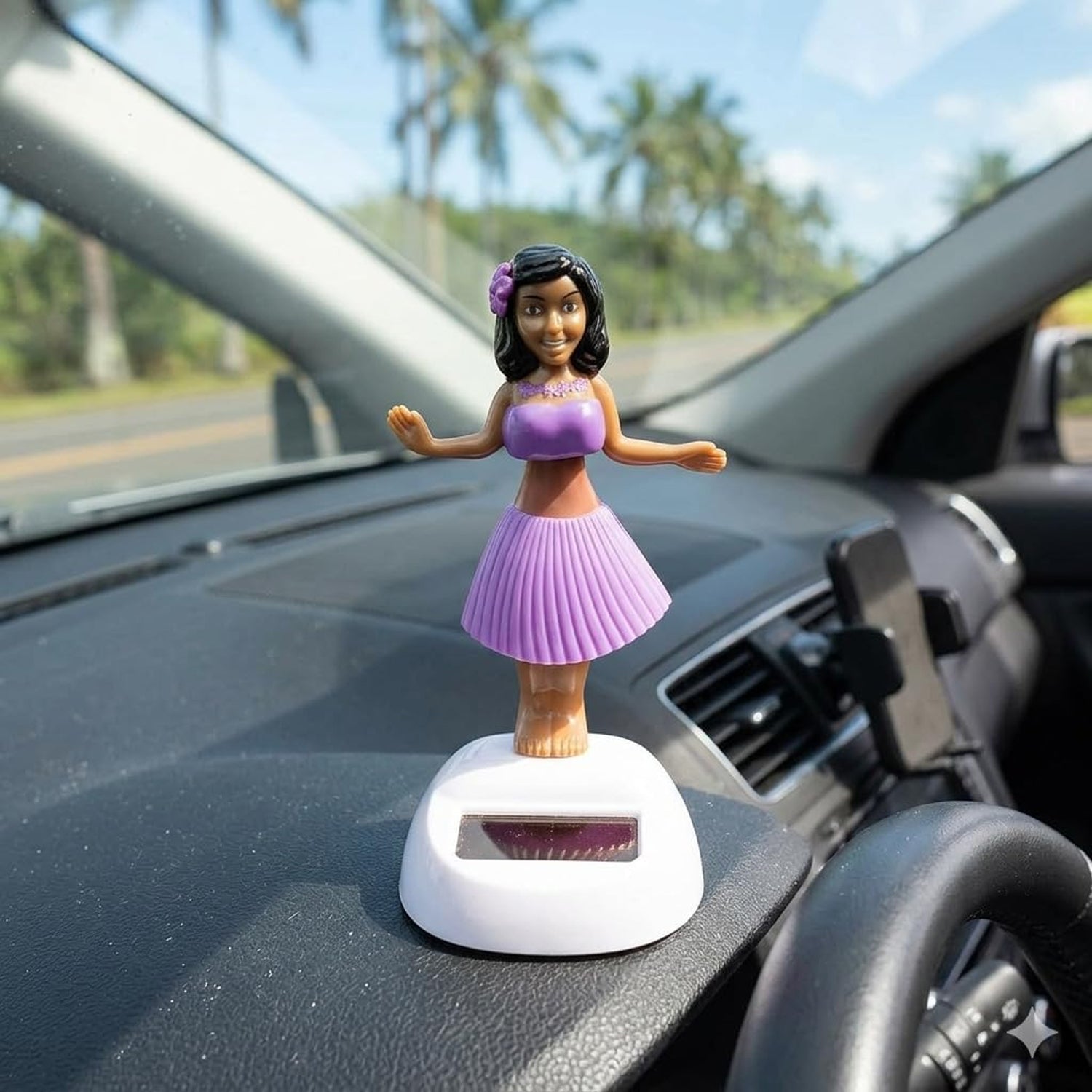 Wukusy solar-powered dancing hula doll bobble toy on car dashboard, featuring a colorful hula dancer with a grass skirt and floral top.