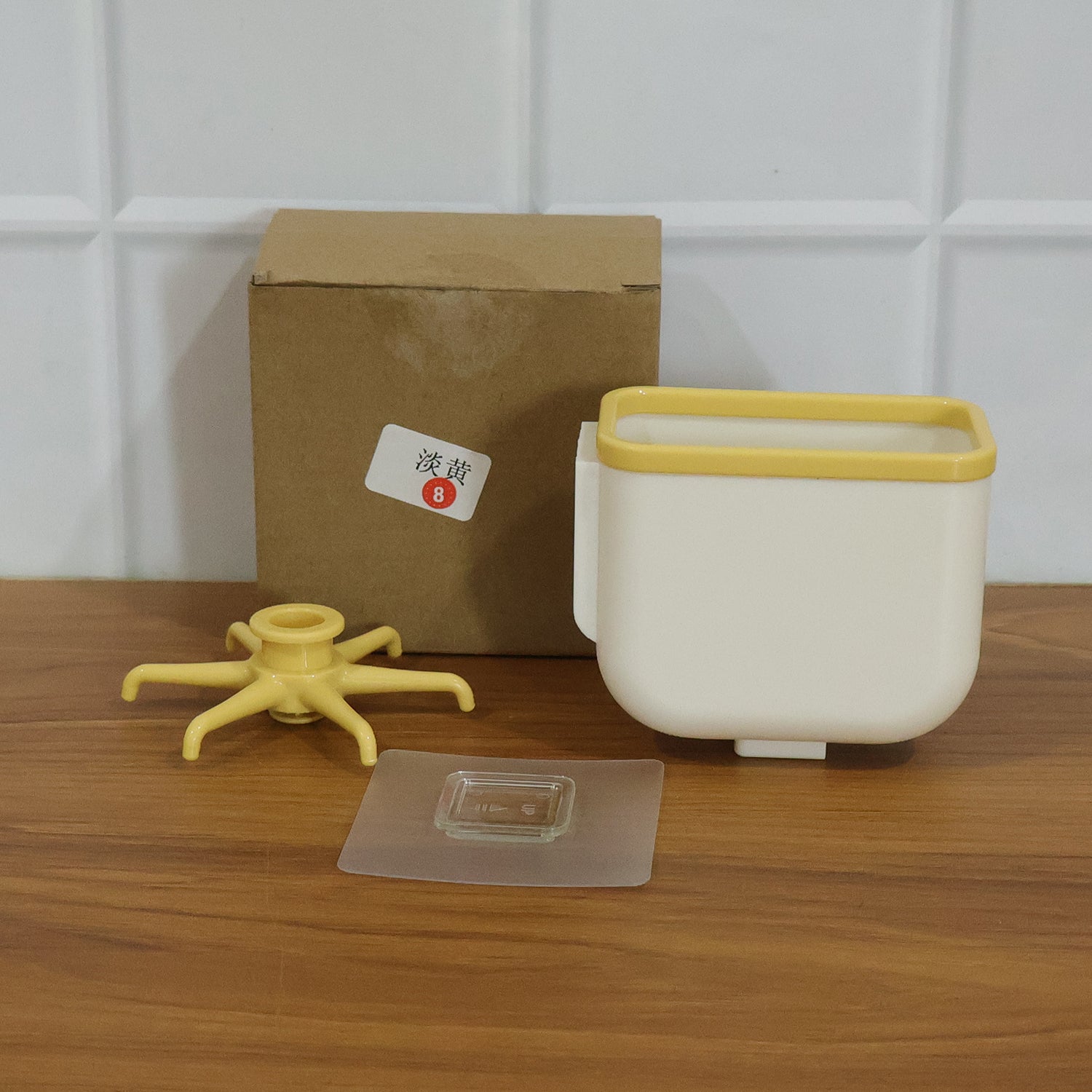Wukusy 360 rotating heavy-duty sticky wall hook mounted on a wall, showcasing its sturdy design and versatile storage capacity