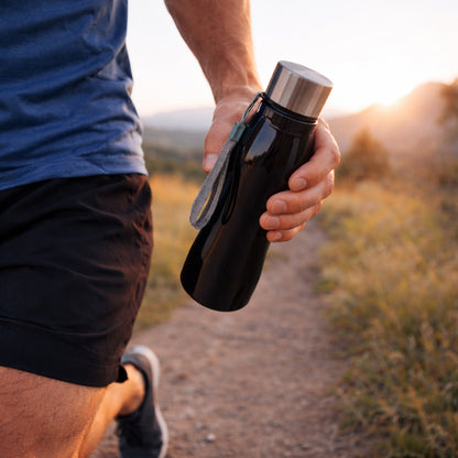 Stainless steel Wukusy water bottle with 600ml capacity and carry strap, shown with a sleek, metallic finish and ergonomic design.