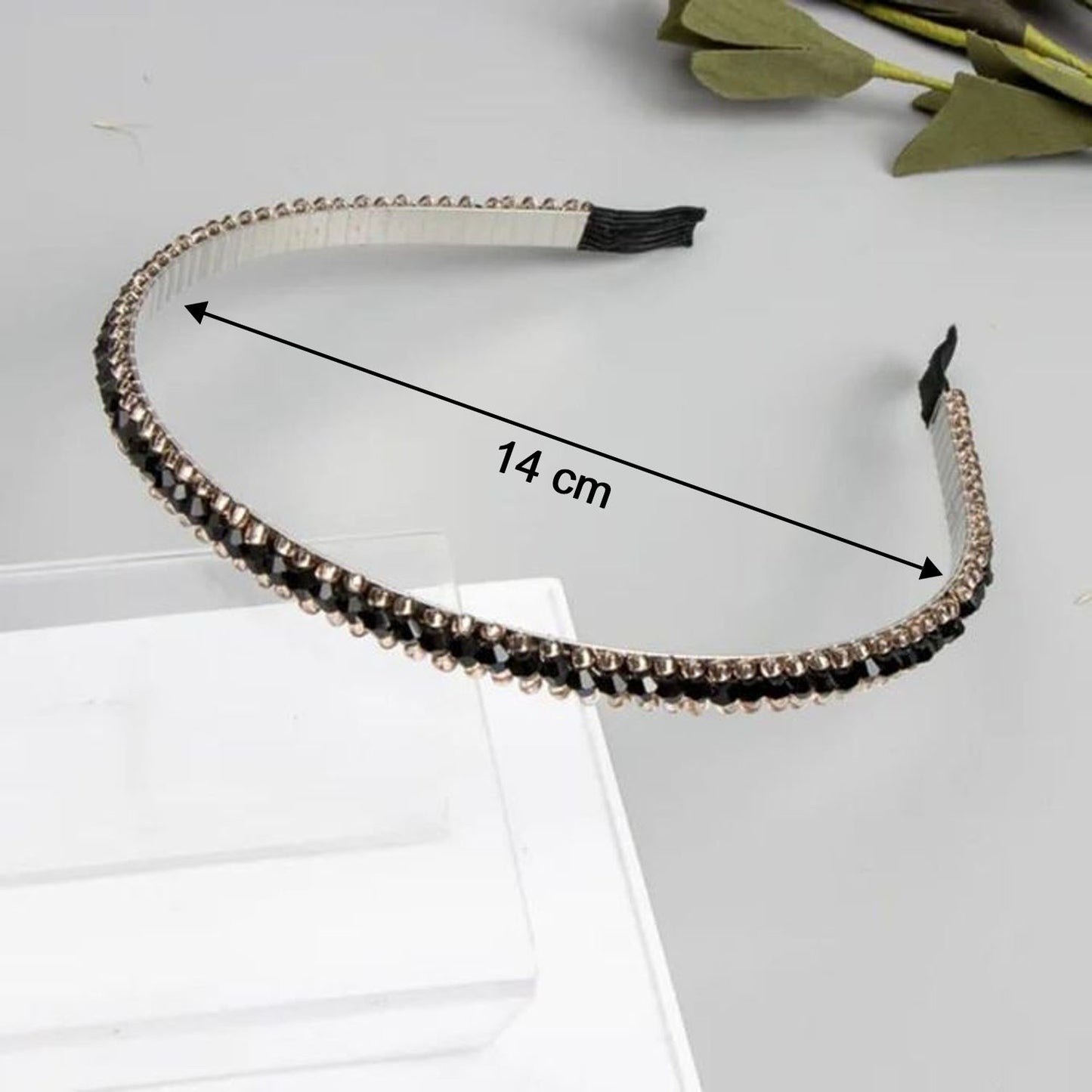 Elegant black metal hair band with crystal studs, Wukusy brand, stylish accessory for women, visible with shiny crystals and intricate design.