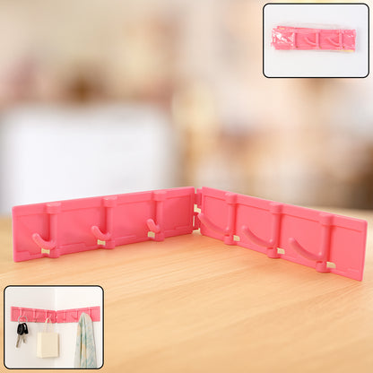 Wukusy foldable wall-mounted 6-hook rack with rotating design, ideal for home and kitchen organization, mounted on a wall.