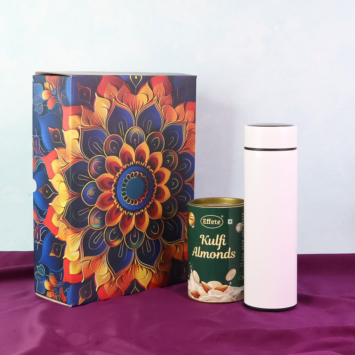 Wukusy Effete Kulfi Almonds Gift Hamper with golden accents and a bottle, featuring a 2-piece set for home and kitchen use.