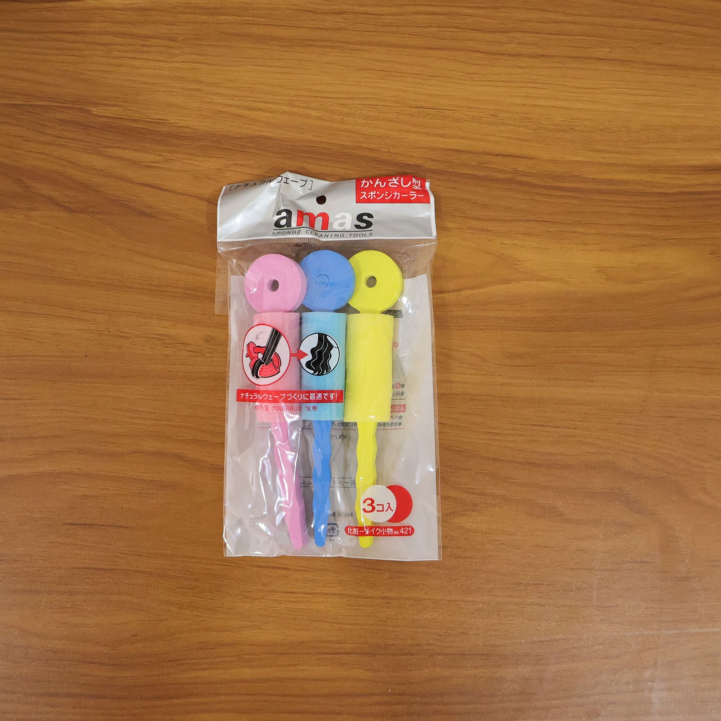 Three Wukusy soft foam hair curling rollers in pink and purple, showing their lightweight, plush design for gentle styling