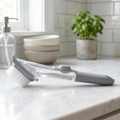 Wukusy soap dispensing dish scrub brush with refillable handle and bristles for kitchen cleaning, shown in close-up.