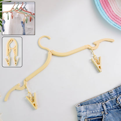 Wukusy foldable cloth hanger with dual clips for versatile home use, shown with clothing and fabric hanging on the hanger.
