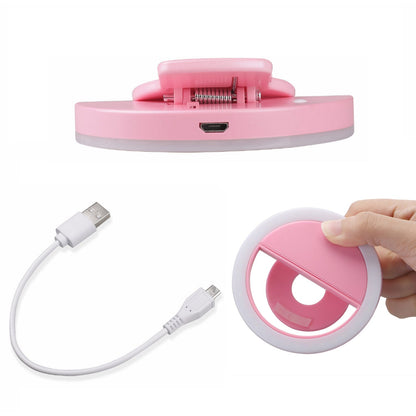 Wukusy 4785 Selfie Ring Light illuminating face for selfies and videos with bright, even lighting during photo shoots.