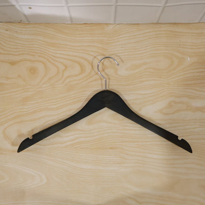 Wukusy premium cloth hanger with metal hook for shirts, coats, and tops, displayed hanging in a wardrobe.