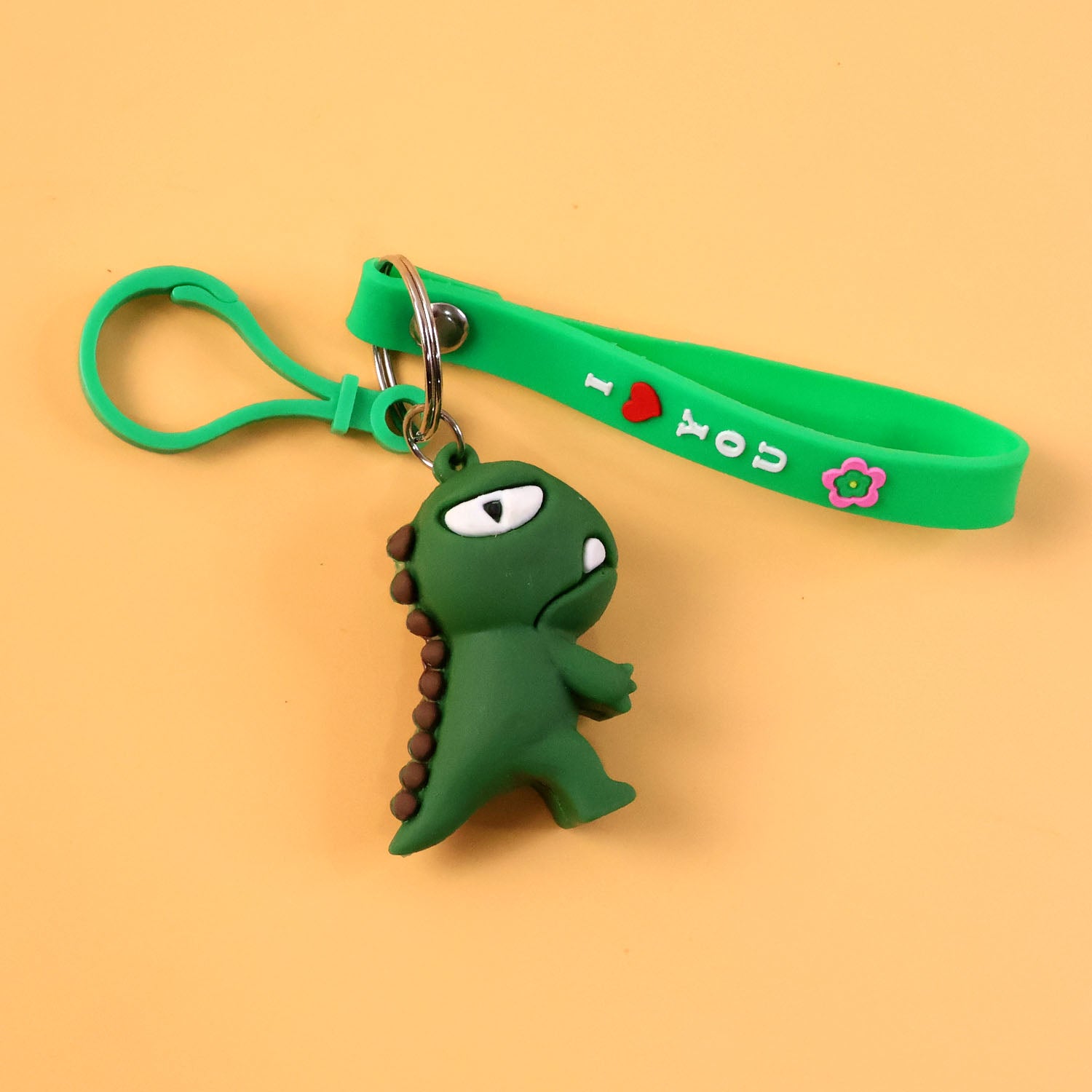 Cute dinosaur cartoon silicone keychain from Wukusy featuring a colorful, playful dinosaur design on a keyring.