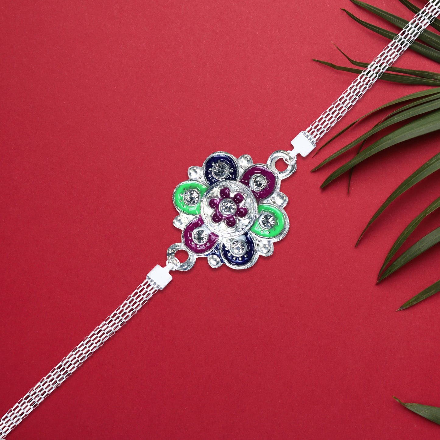 Silver flower motif Rakhi with intricate design, featuring elegant floral patterns and detailed craftsmanship by Wukusy.