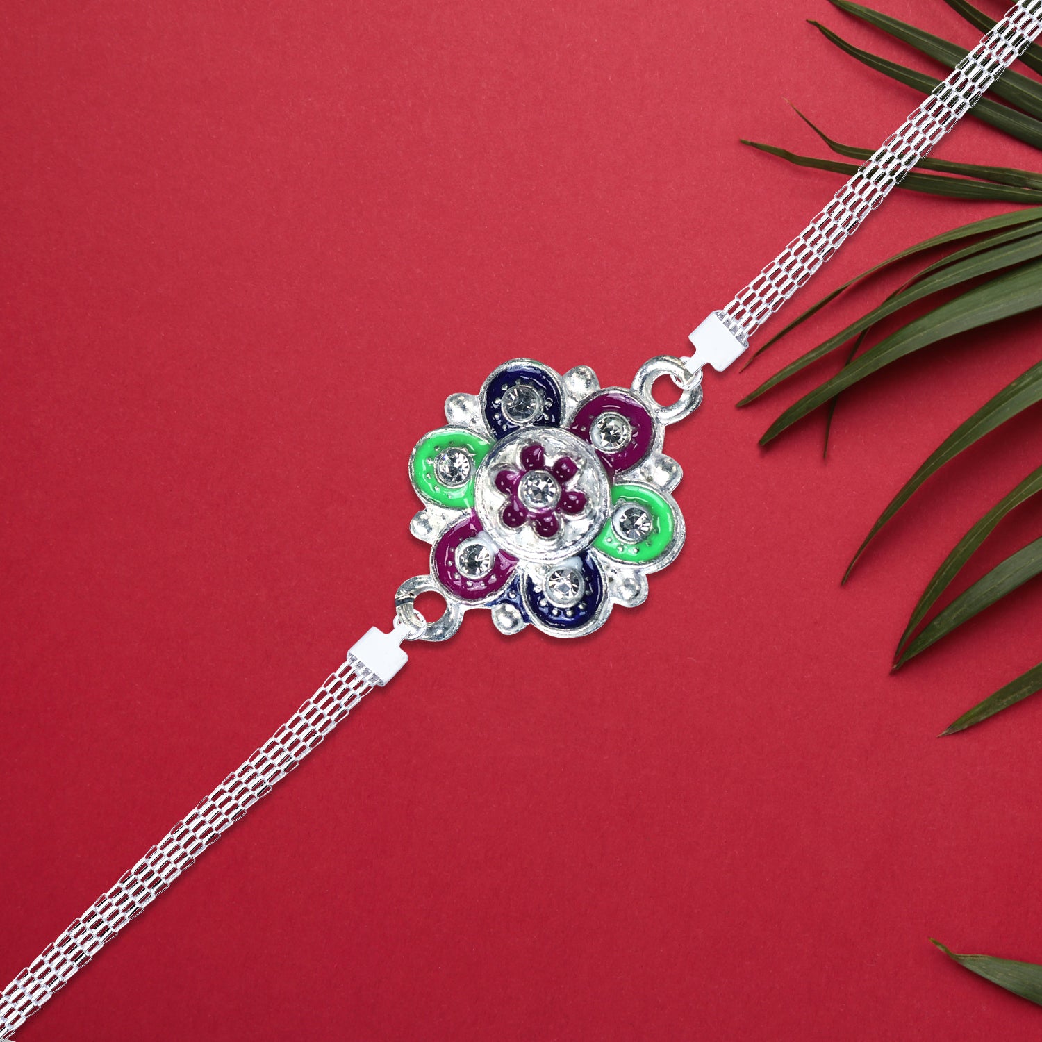 Silver flower motif Rakhi with intricate design, featuring elegant floral patterns and detailed craftsmanship by Wukusy.