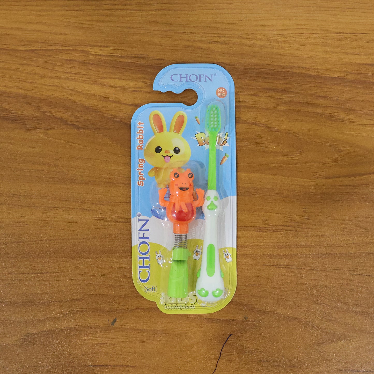 Kids cartoon spring frog toy with toothbrush set, colorful 2-piece Wukusy kids' bath toy and dental hygiene accessory.