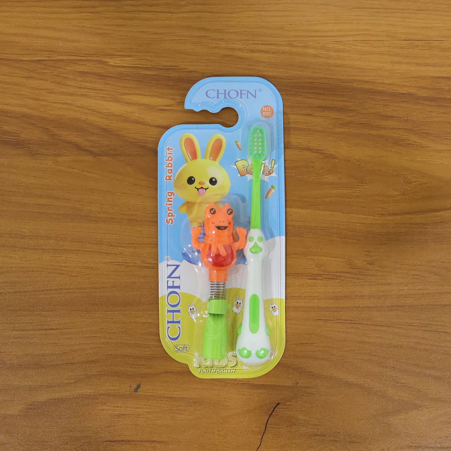 Kids cartoon spring frog toy with toothbrush set, colorful 2-piece Wukusy kids' bath toy and dental hygiene accessory.