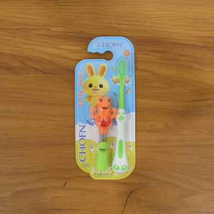 Kids cartoon spring frog toy with toothbrush set, colorful 2-piece Wukusy kids' bath toy and dental hygiene accessory.