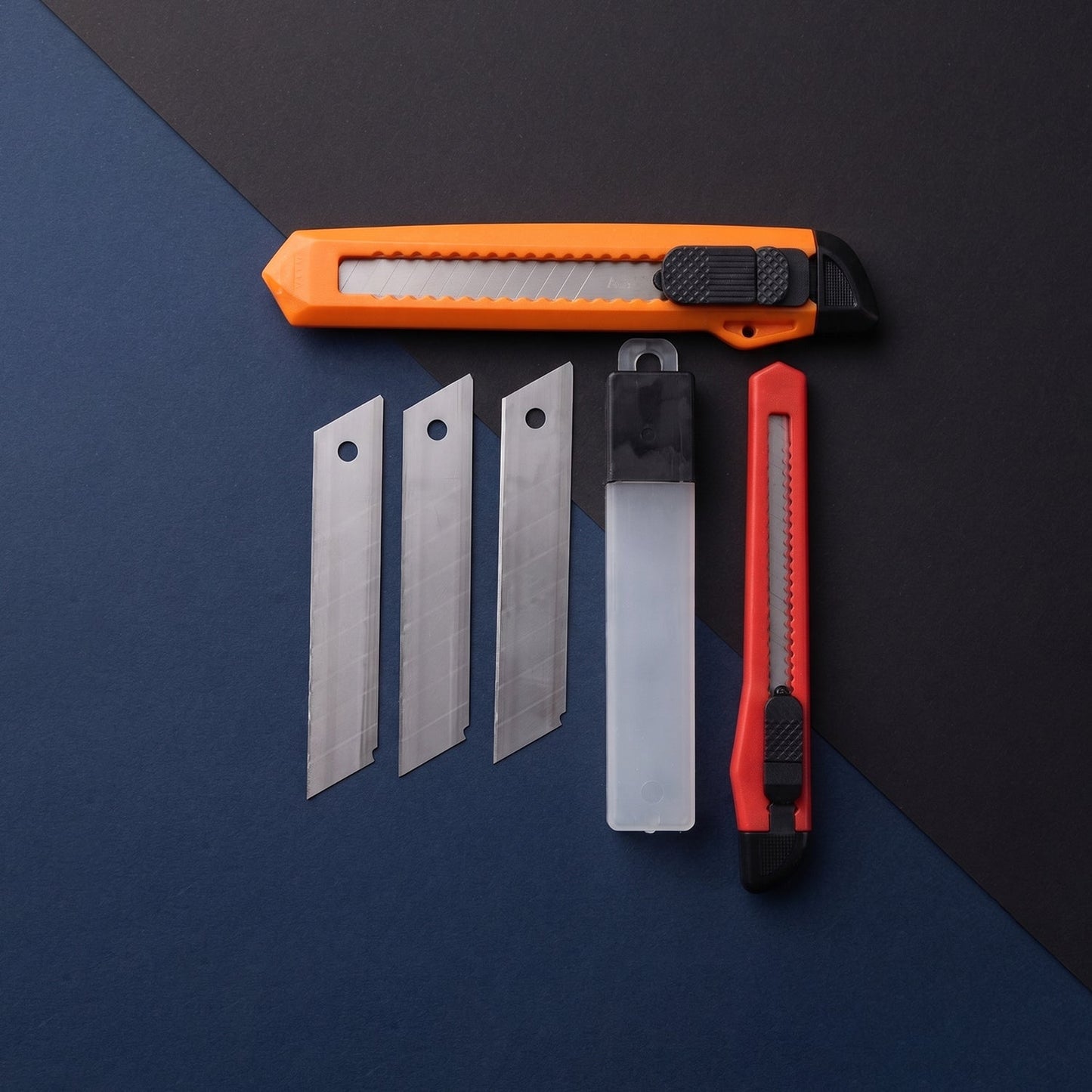 Wukusy professional utility knife cutter set with extra snap-off blades, shown with a black handle and multiple blade segments.