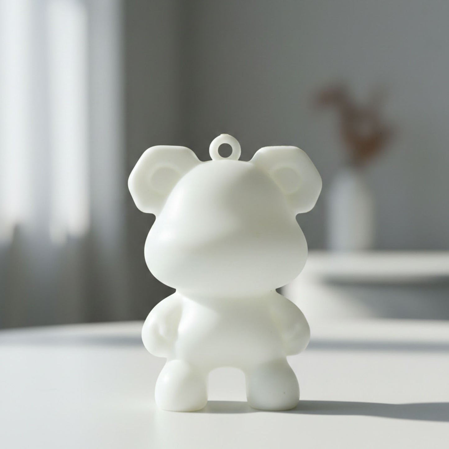 Wukusy cute bear shape mini figure keychain attached to a keyring, featuring a small, detailed bear design perfect for keys or bags
