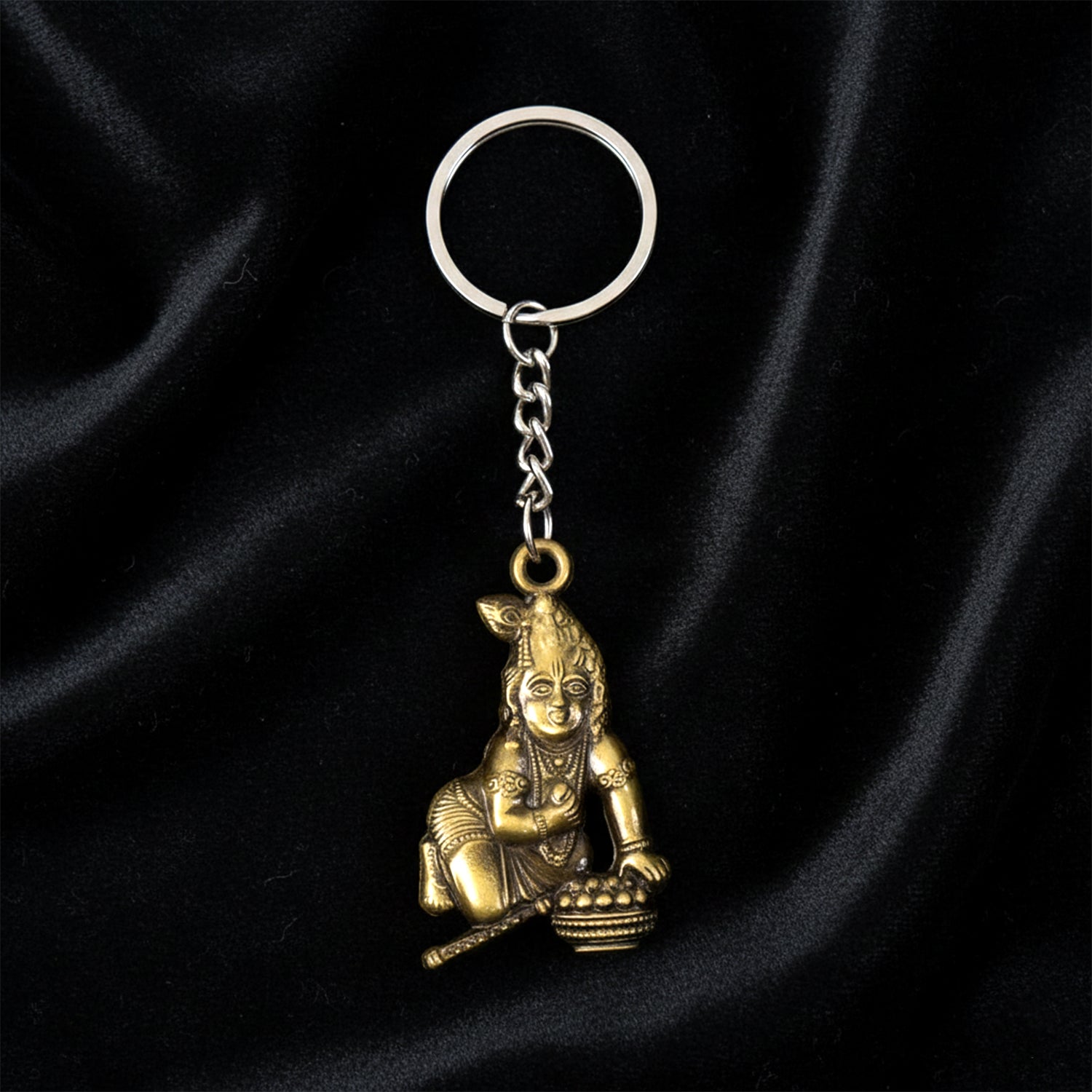 Antique-gold Bal Krishna Makhan Chor keychain by Wukusy featuring detailed metal craftsmanship and traditional design.
