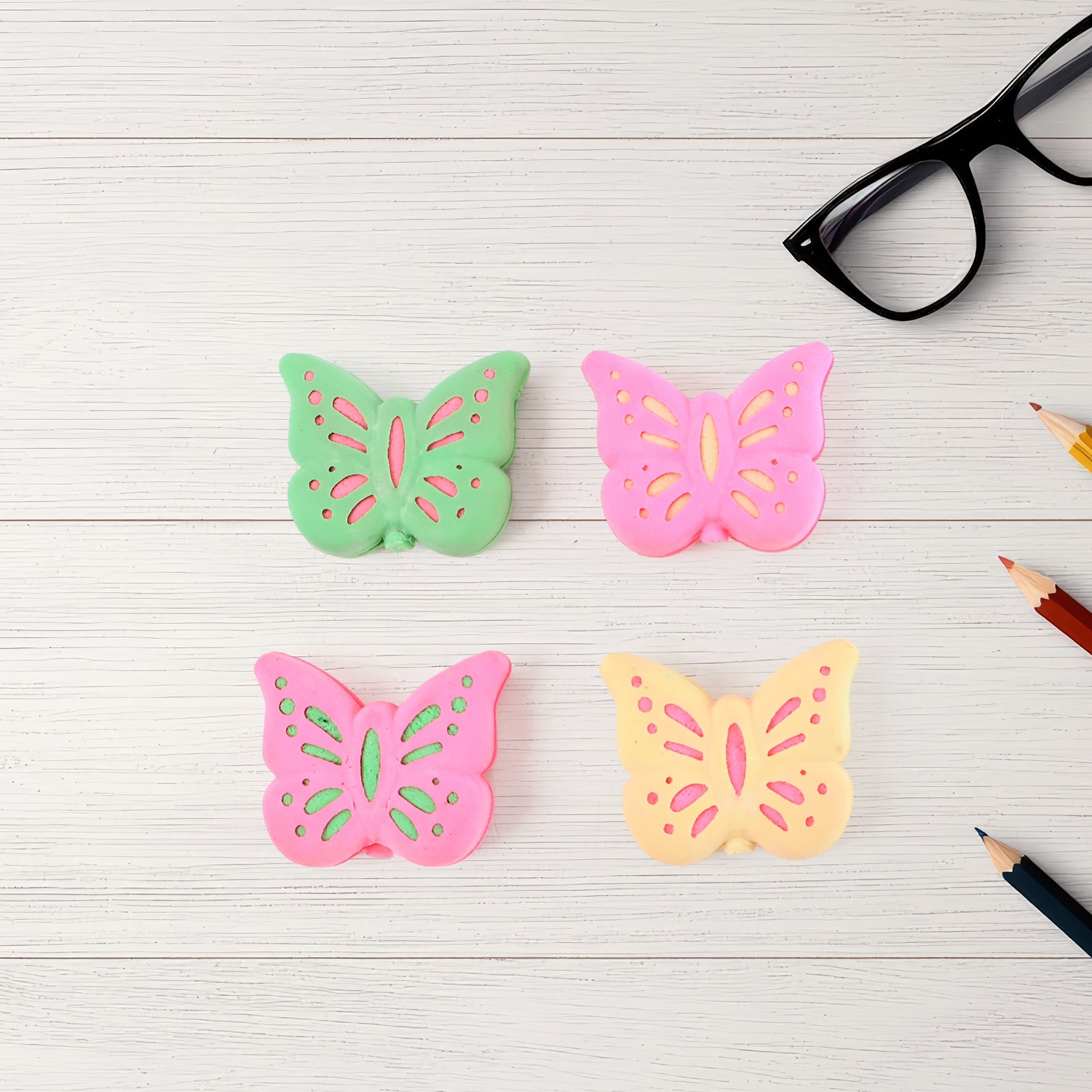 Set of 25 colorful butterfly-shaped rubber erasers by Wukusy, perfect for office and school use.