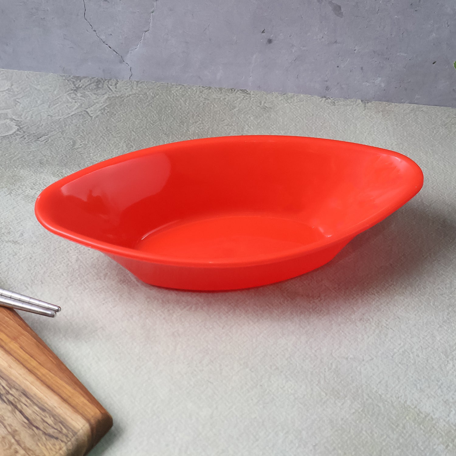 Red plastic Marin serving bowl by Wukusy, elegant oval deep bowl for home and kitchen use.