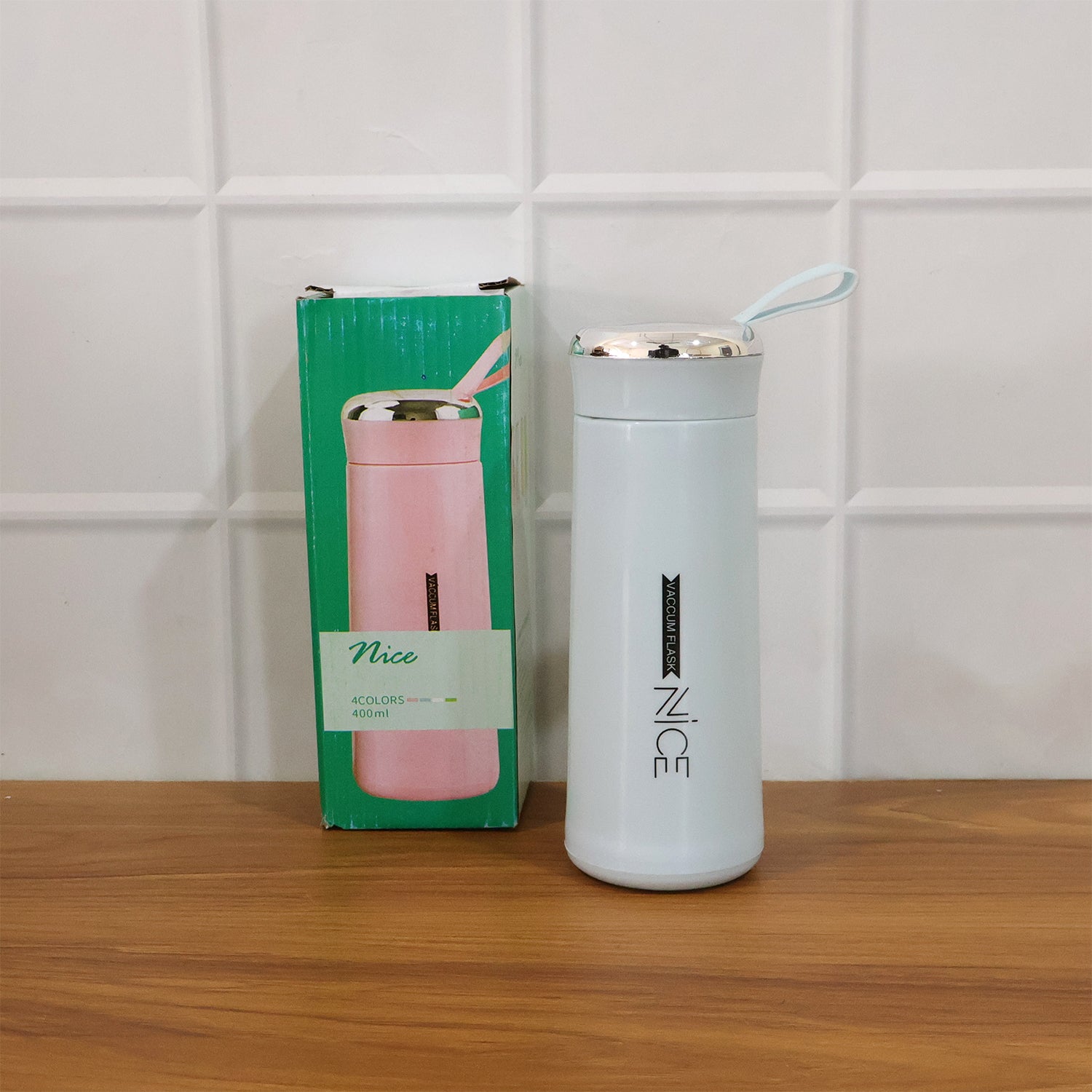 Wukusy leak-proof glass water bottle with blue lid and clear body, standing upright on a white background.