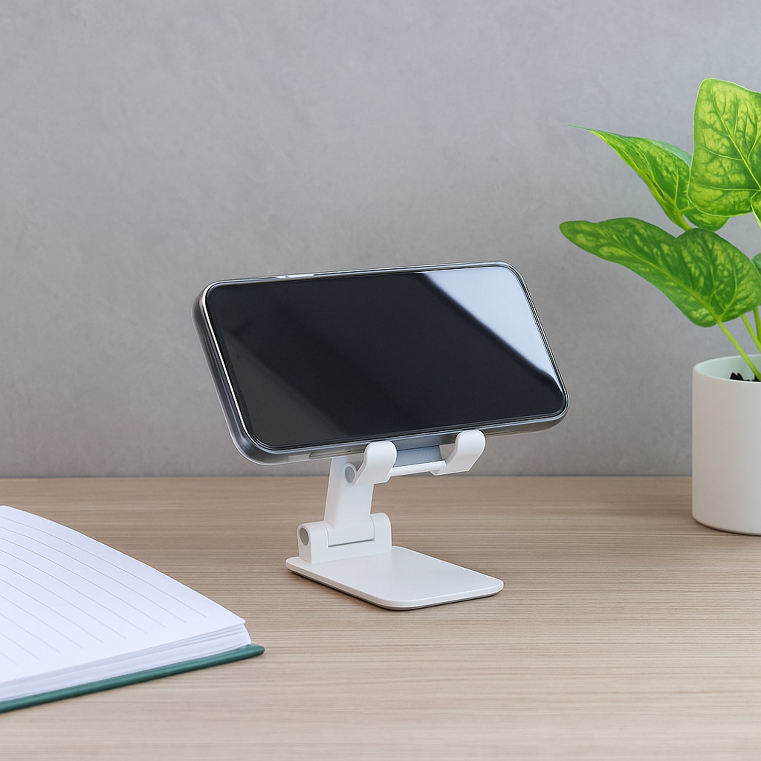 Adjustable foldable Wukusy mobile stand for desktop, supporting smartphones in various viewing angles.