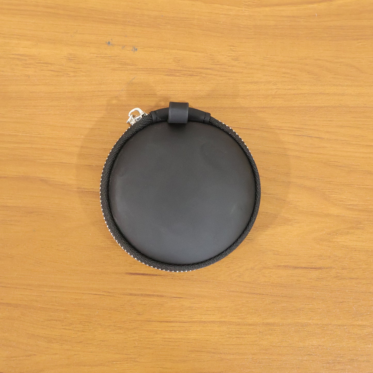 Wukusy compact hard shell earphone carrying case with zipper closure, designed to protect and store earphones securely.