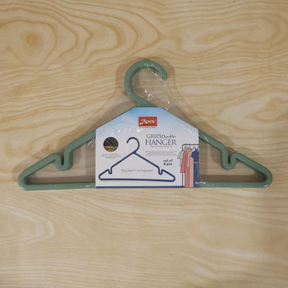 Six durable plastic Wukusy Apex Gripi cloth hangers hanging in a wardrobe for organizing clothes.