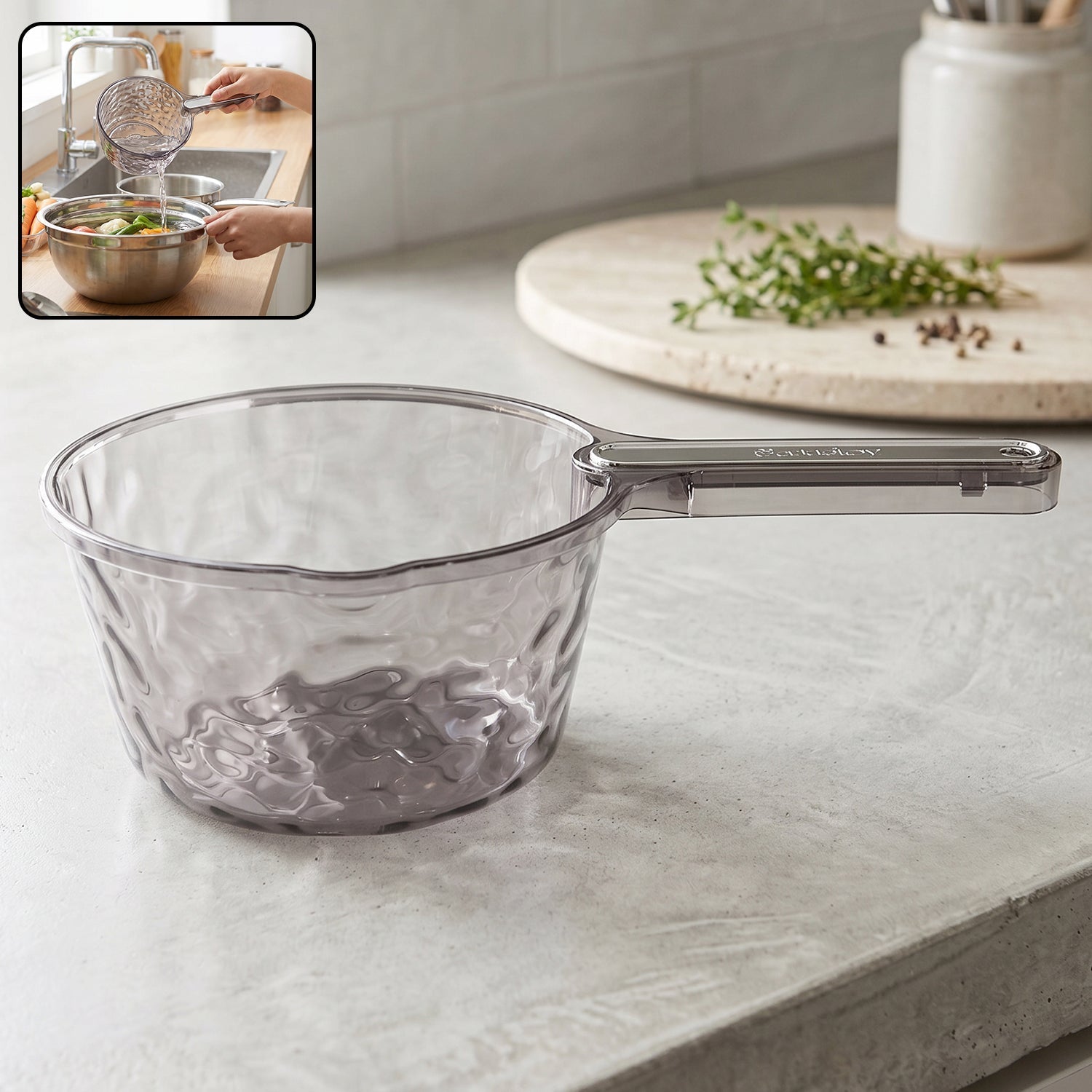 Transparent plastic water dipper scoop with handle for bathroom use, designed by Wukusy, shown with water and bathroom setting.