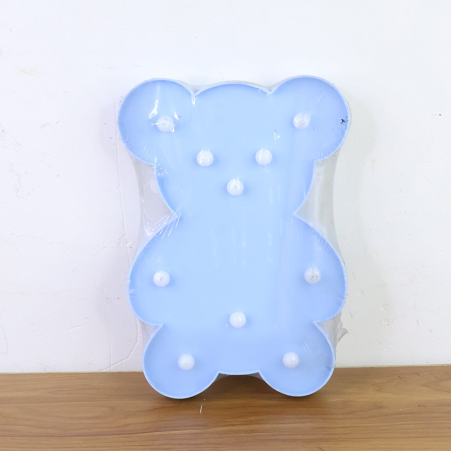 Wukusy teddy bear-shaped LED night light providing a soft glow, perfect for home decor and children's bedrooms.