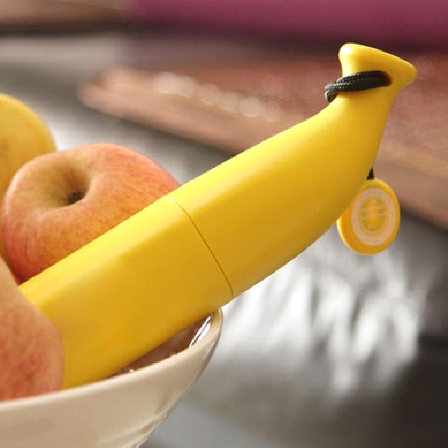 Wukusy stylish banana-shaped mini foldable travel umbrella open, featuring bright yellow canopy and compact design for portability.