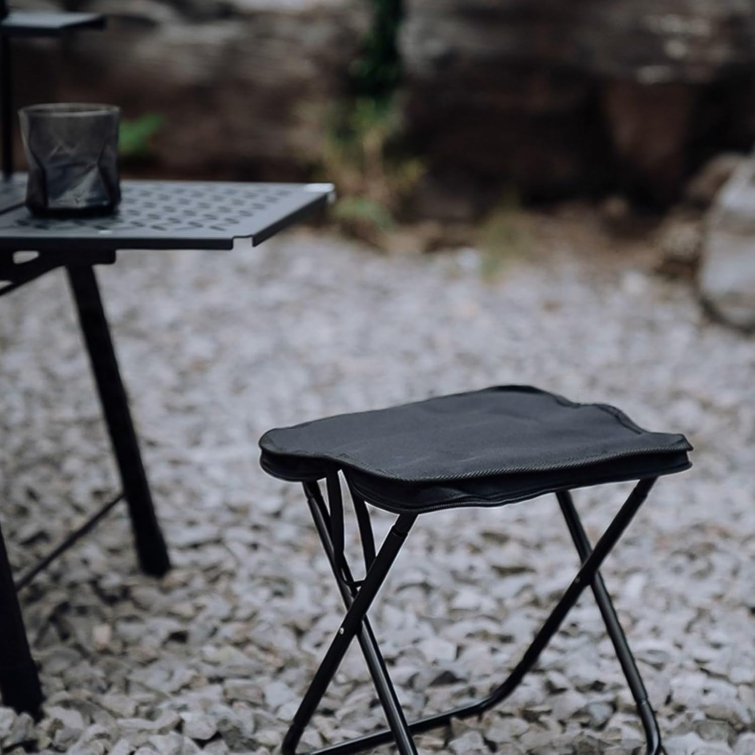 Wukusy portable folding camping stool, collapsible camp seat for outdoor travel, compact and lightweight for easy carrying.