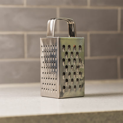 Wukusy Supermom Premium 4-in-1 stainless steel grater and slicer for kitchen use, compact design with multiple grating and slicing options.