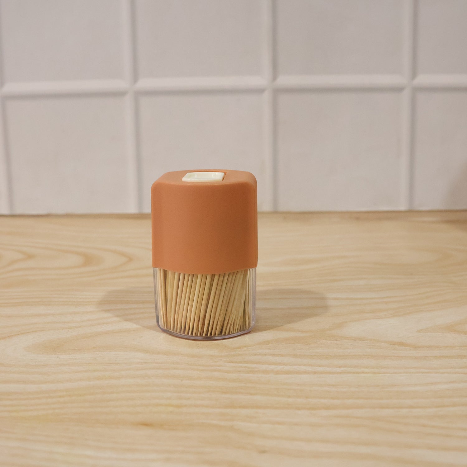 Wukusy toothpick dispenser box set with automatic pop-up holder on a dining table, sleek design for convenient toothpick access.