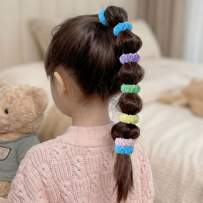 Set of 8 soft terry elastic hair bands by Wukusy, showcasing stretchy, gentle hair ties in various colors for everyday styling.