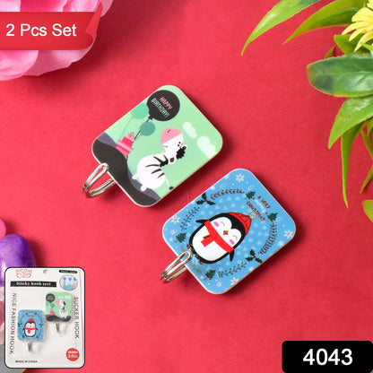 Two Wukusy multipurpose cartoon self-adhesive hooks for home and kitchen use, mounted on a wall for hanging small items.