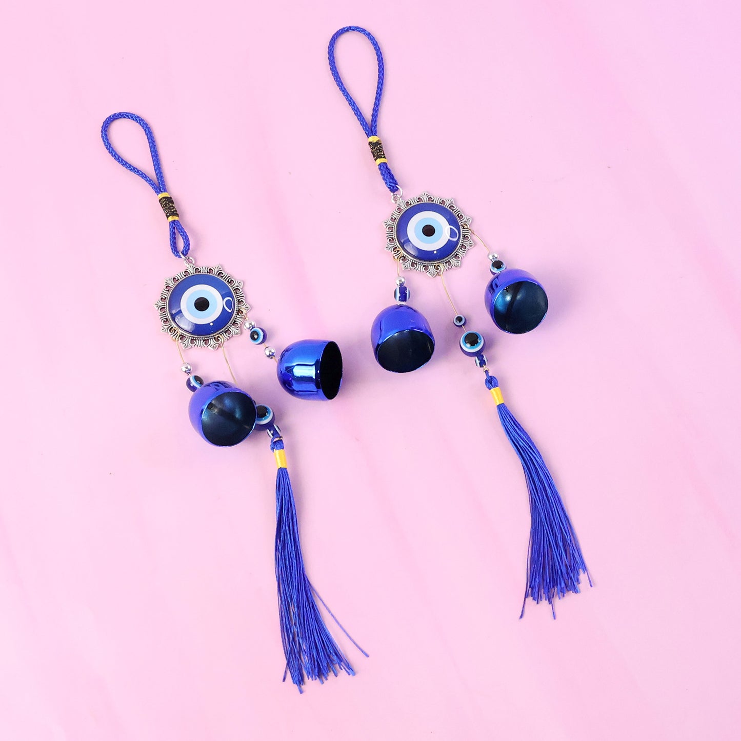 Decorative evil eye hanging wind chime set with two colorful glass charms and metal bells, perfect for outdoor or indoor decor.
