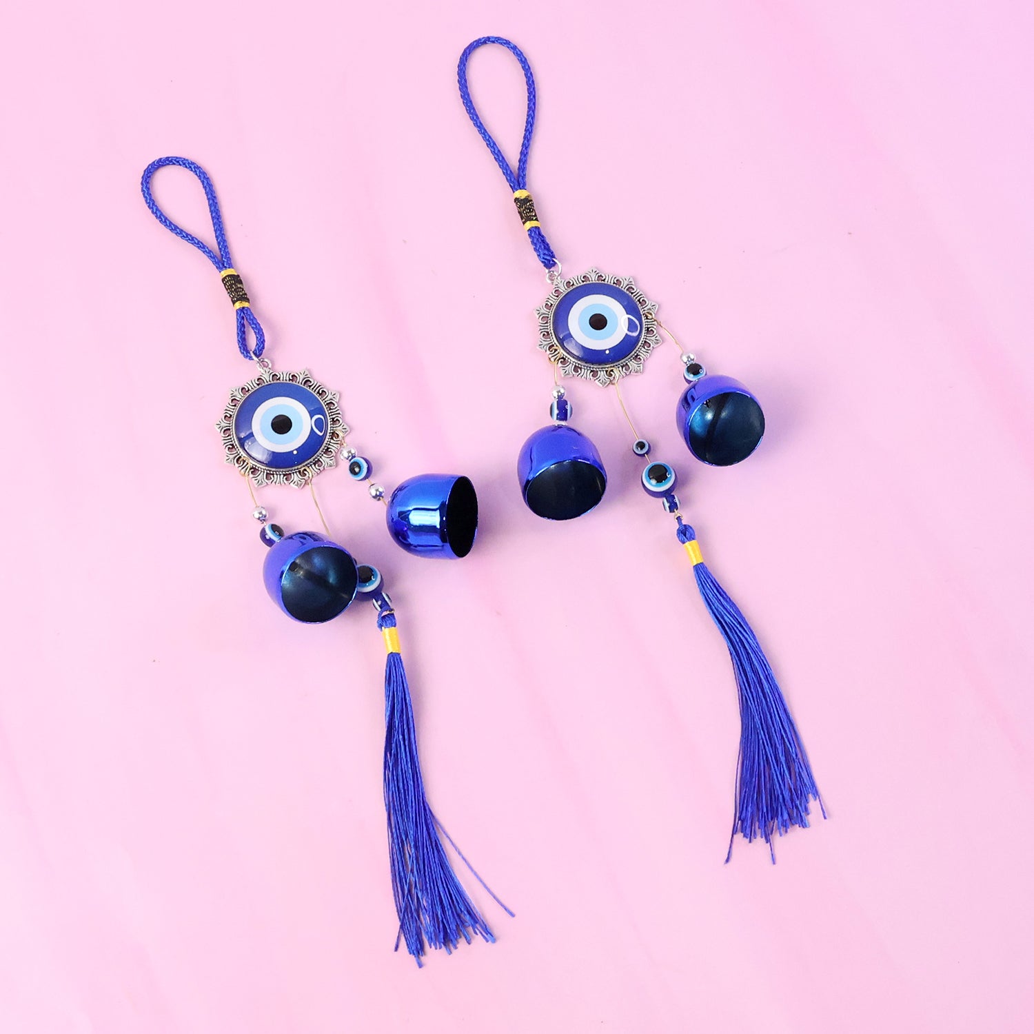 Decorative evil eye hanging wind chime set with two colorful glass charms and metal bells, perfect for outdoor or indoor decor.