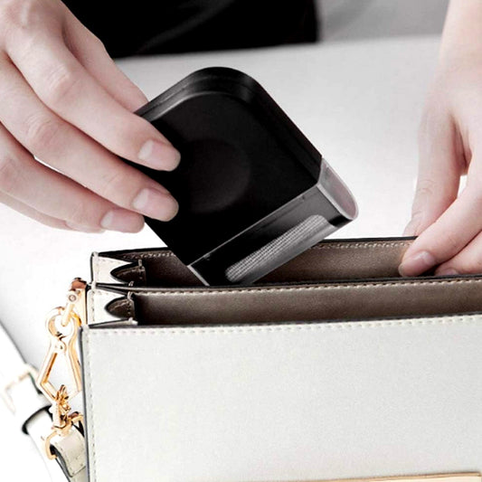 Wukusy portable clothes lint remover with razor blade for removing lint, fuzz, and pet hair from clothes and fabric surfaces.