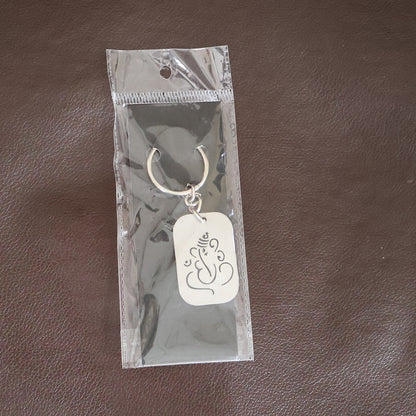 Metal Ganesh keychain with auspicious cut-out design by Wukusy, featuring detailed craftsmanship and keyring attachment.