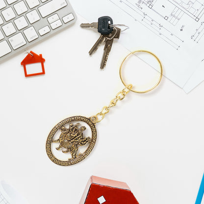 Golden metal Durga Maa keychain accessory with intricate design, featuring a detailed Durga Maa figure, by Wukusy.