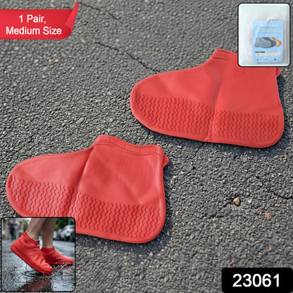 Pair of red waterproof silicone shoe covers in medium size by Wukusy, showing the flexible, protective material over shoes.