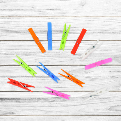 Set of 144 Wukusy multi-purpose plastic clothes clips for drying and home use, shown in a variety of open and closed positions.