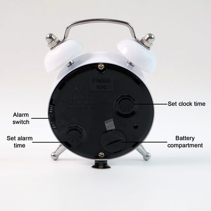 Small Wukusy twin-bell analog alarm clock with classic design, white face, black hands, and metal bells on top for home use.