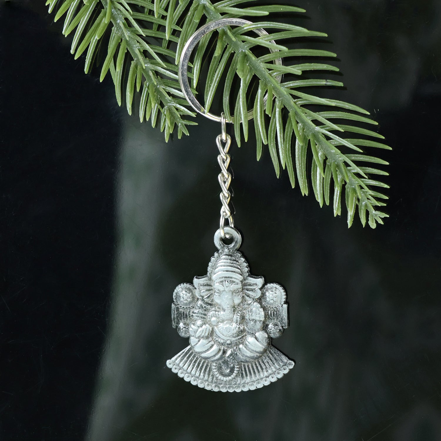 Silver Lord Ganesha sitting design keychain by Wukusy, featuring detailed Ganesha figure on a compact keychain.