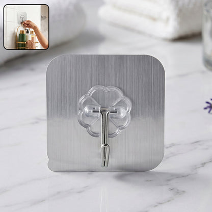 Transparent heavy-duty self-adhesive wall hook by Wukusy mounted on a wall for hanging items.